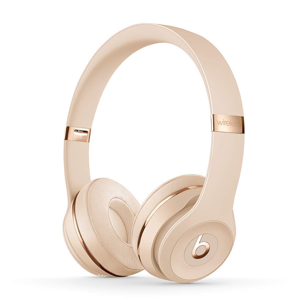 Rose gold Beats headphones on a white background