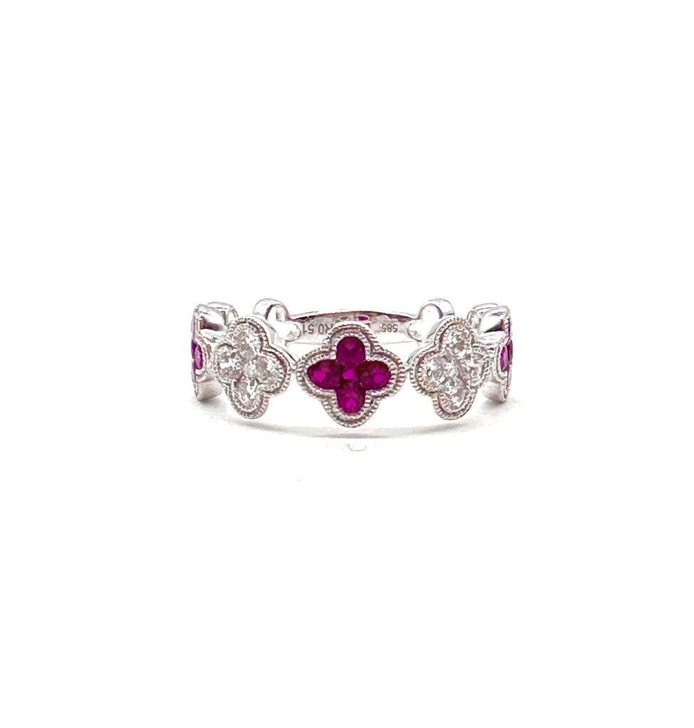 Silver ring with purple gemstones on a white background