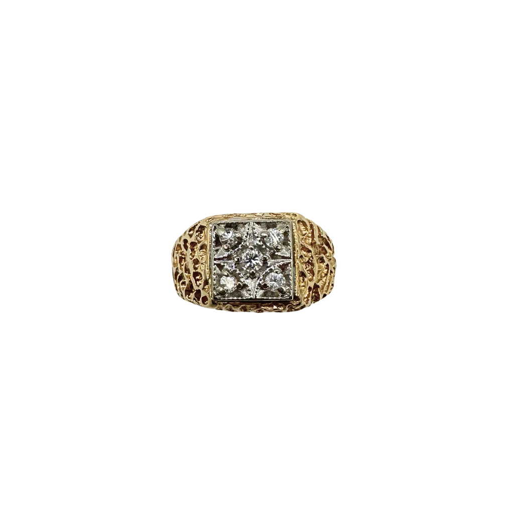 Gold ring with diamond centerpiece on a white background