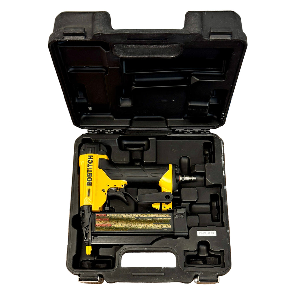 BOSTITCH 23-Gauge 2" Pneumatic Pin Nailer w/ Hard Case (BTFP2350) Bostitch nail gun in a black carrying case on a wooden floor.