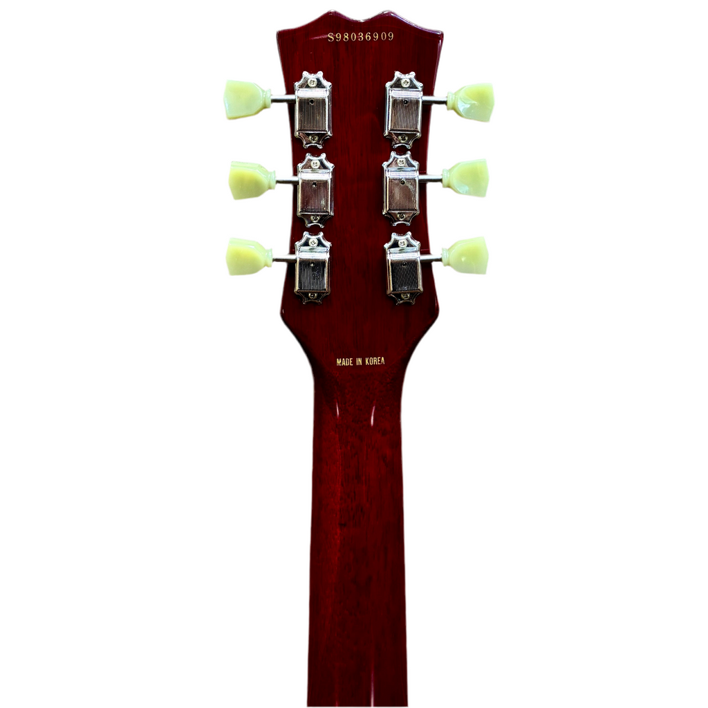 Samick Artist Series Edition Les Paul Style Left-Handed Electric Guitar Close-up of a guitar's headstock with tuning pegs on a white background