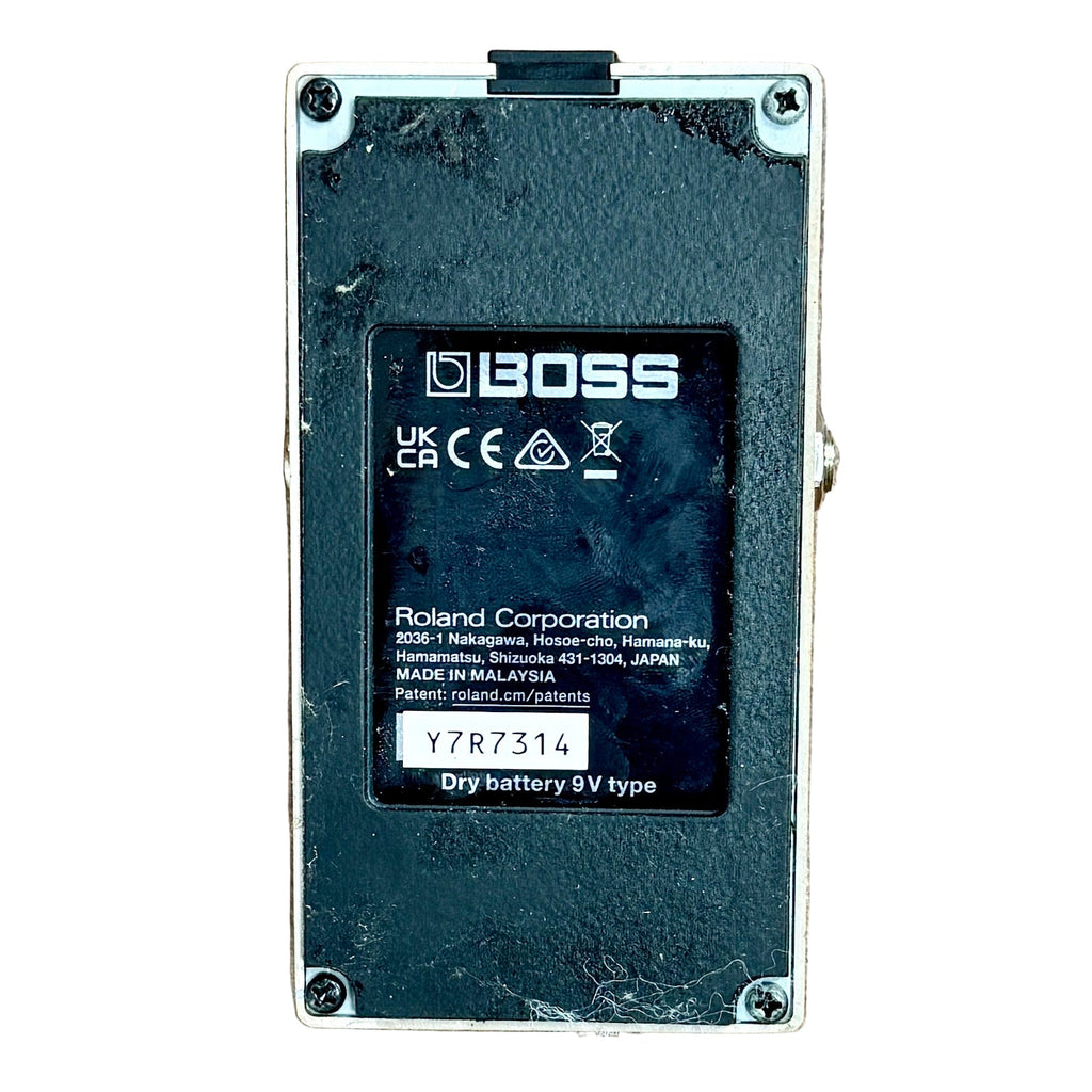 BOSS DS-1 Distortion Guitar Effects Pedal Boss battery pack on a wooden surface