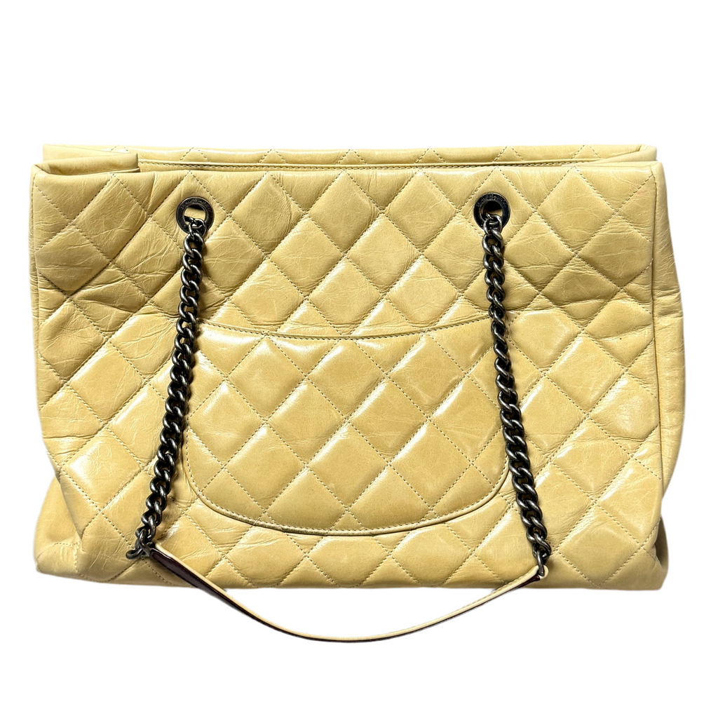 CHANEL Glazed Calfskin Leather Quilted Small Duo Color Tote Bag - Beige Quilted beige handbag with black chain handles on a white background