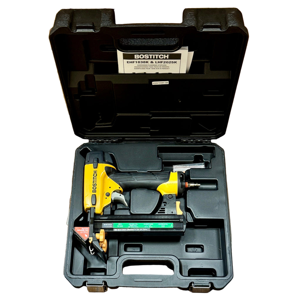 BOSTITCH 18-Gauge 1-1/2" Pneumatic Flooring Stapler w/ Hard Case (EHF1838K) Bostitch nail gun in an open black case on a wooden floor.