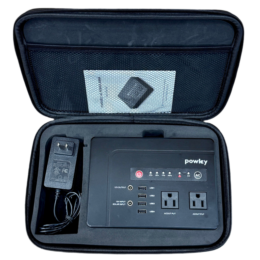 Black portable power station with accessories in an open case on a white background