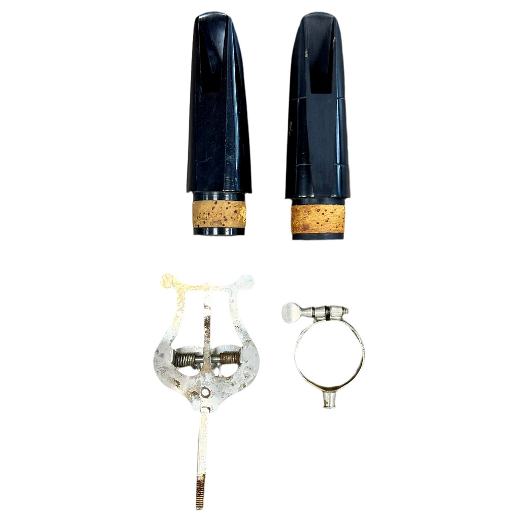 Henkin Bb Clarinet w/ Hard Case Set of clarinet mouthpieces and accessories on a white background