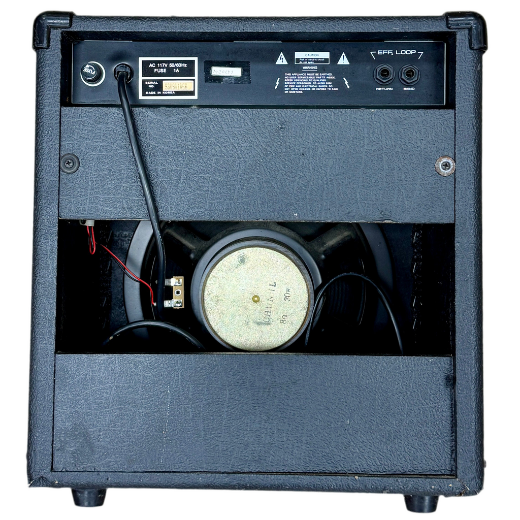 Hondo H-410D Guitar Combo Amplifier Back view of a guitar amplifier with speaker and wiring on a white background