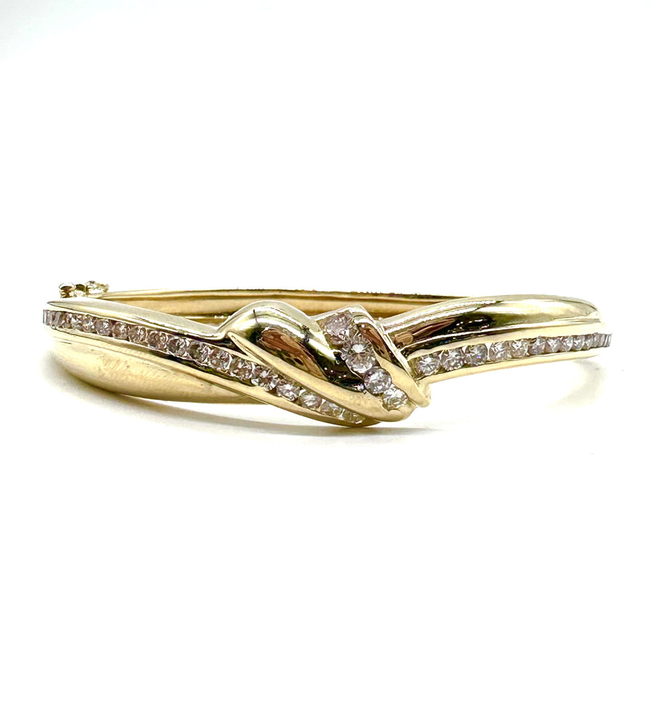 Gold bracelet with diamond accents on a white background
