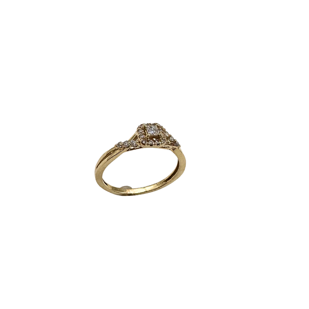 Gold ring with diamond accents on a white background