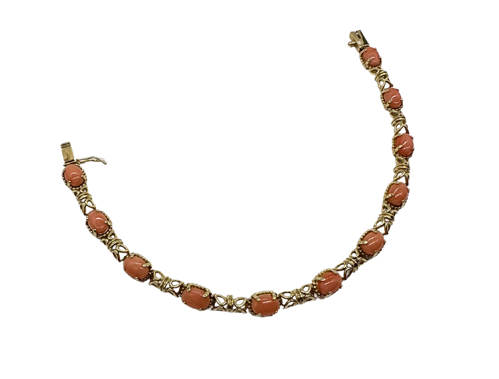 Bracelet with coral beads and gold chain on a white background