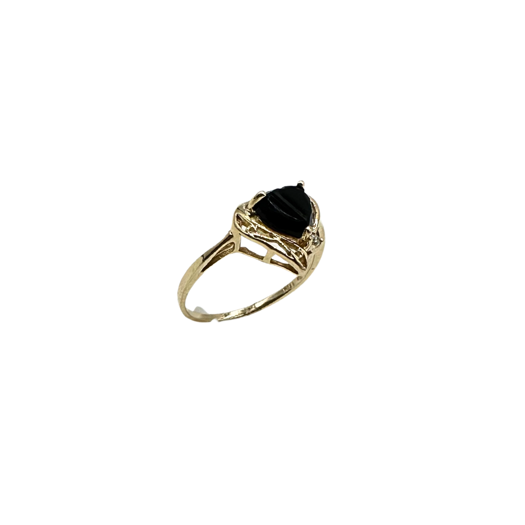 Gold ring with a black gemstone on a white background