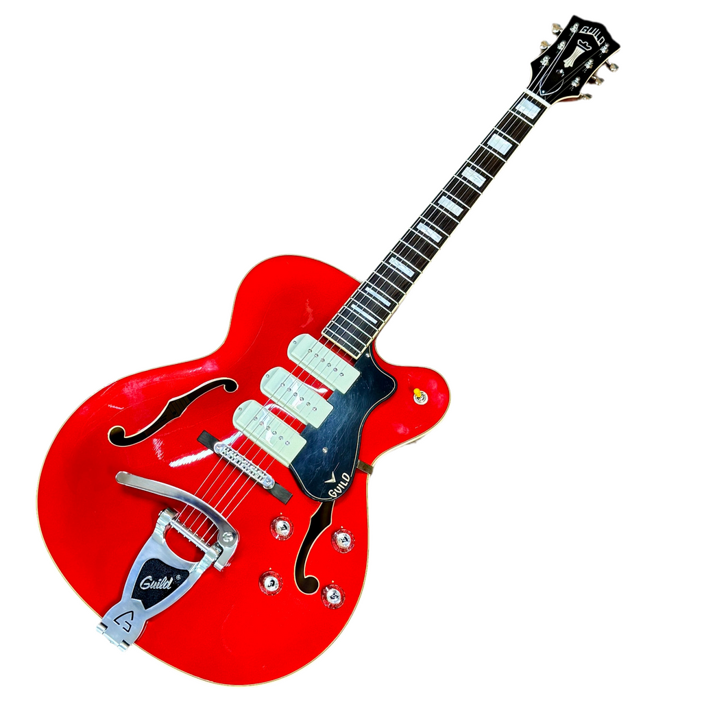 Red guild x-350 stratford electric guitar with a white pickguard on a white background