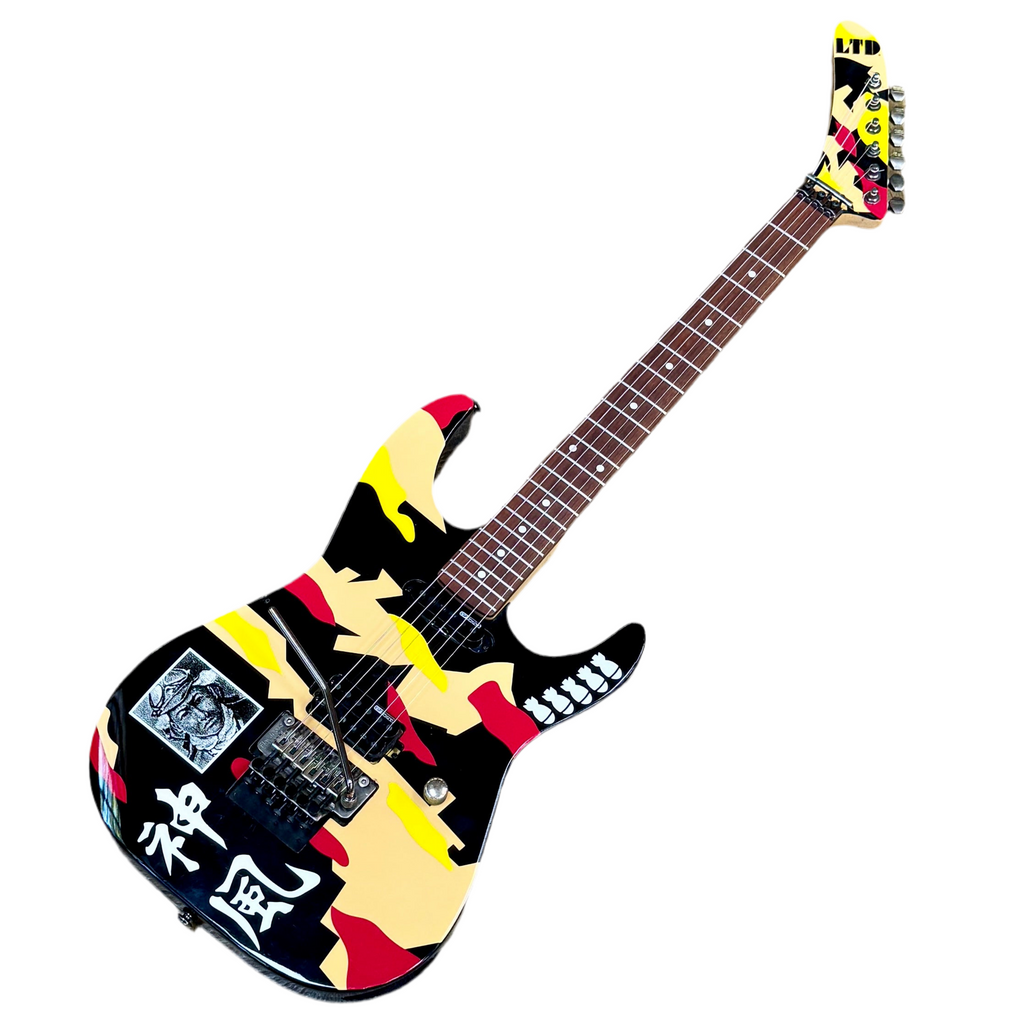 Colorful electric guitar with abstract design on a white background