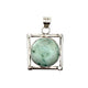Silver pendant with a green gemstone on a white background