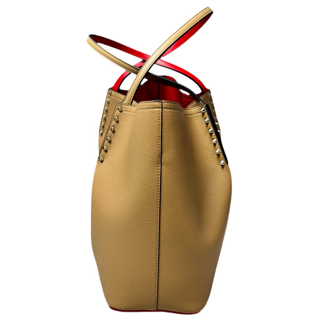 Christian Louboutin Cabarock Large Calfskin Leather Tote Bag - Fennec Beige handbag with red interior and gold studs on a white background
