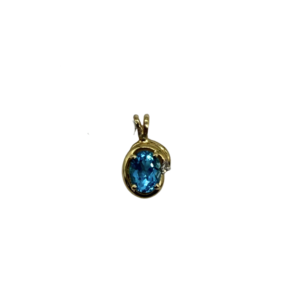 Gold pendant with a blue gemstone on a white background