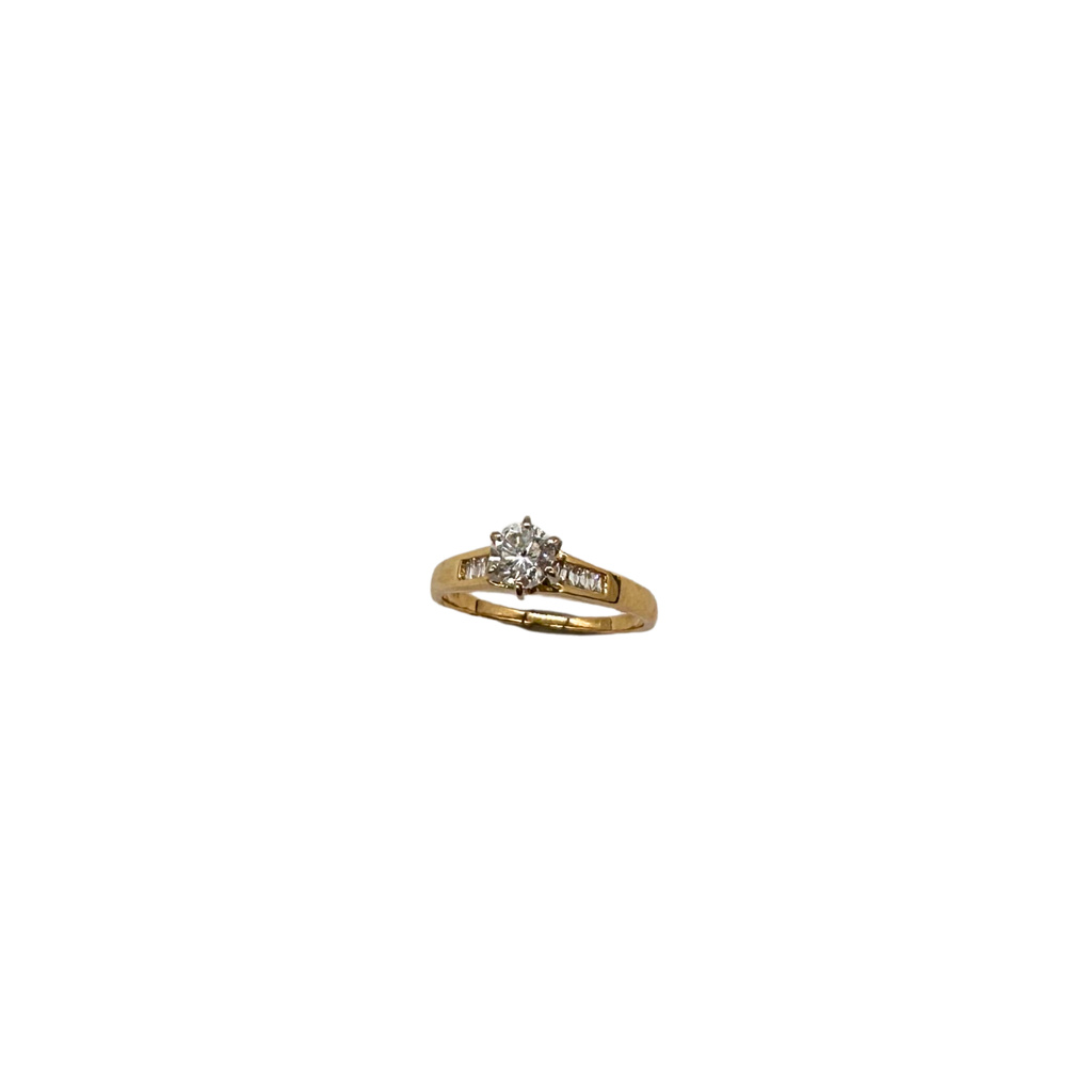 Gold ring with a diamond on a white background