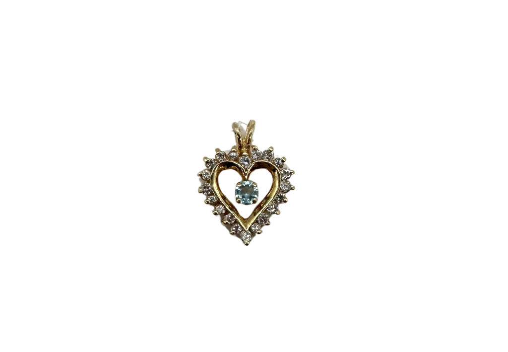 Heart-shaped pendant with a central gemstone on a white background