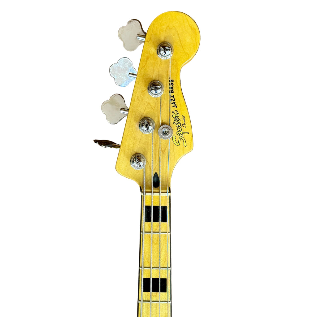 Fender Squier Jazz Bass Electric Bass Guitar w/ Hard Case Guitar headstock with 'Squier' branding on a wooden surface