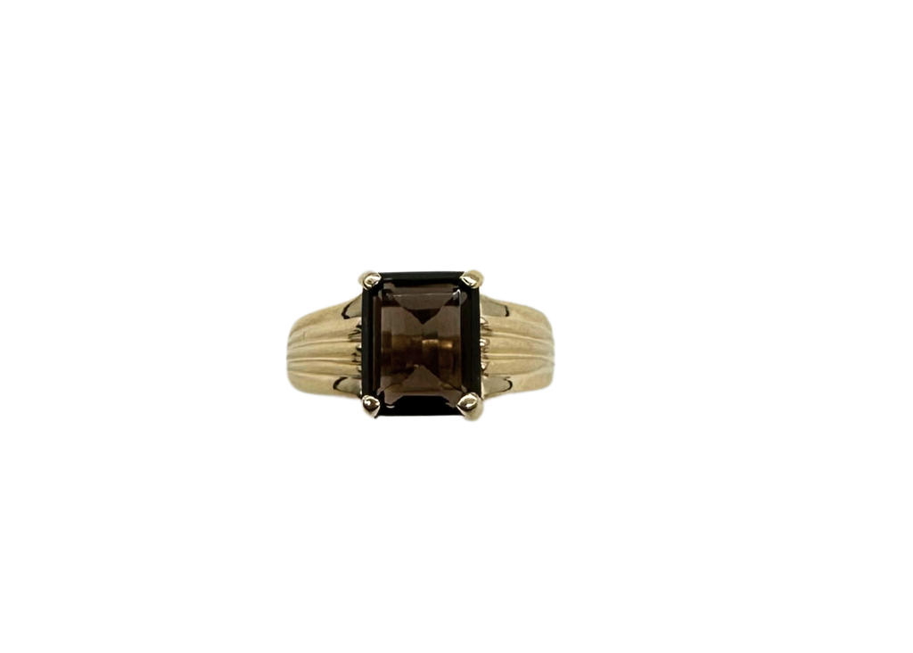 Gold ring with a rectangular smoky topaz stone on a white background