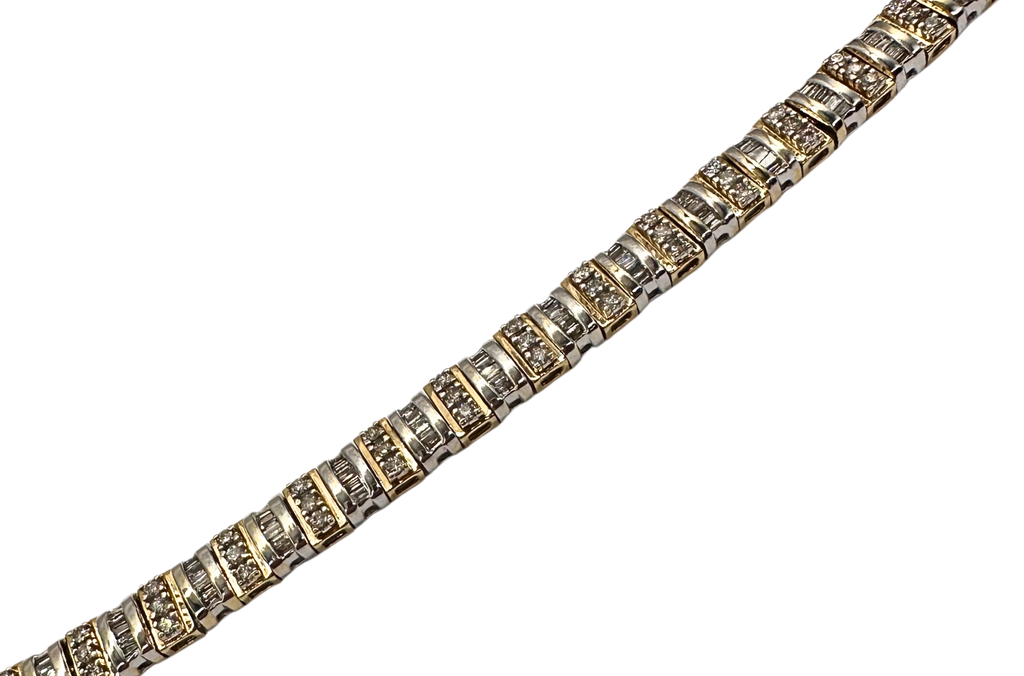 Gold bracelet with diamond accents on a white background