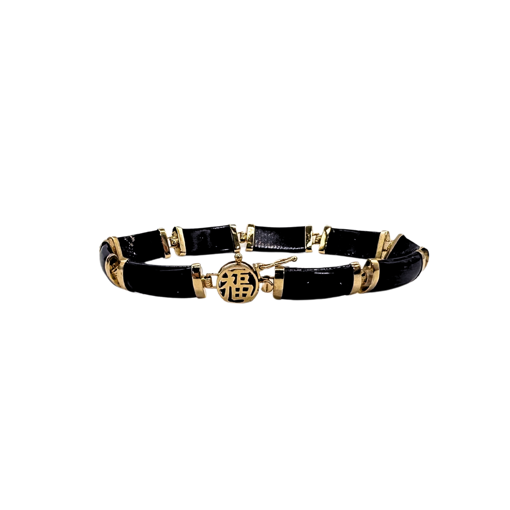 Black and gold bracelet on a white background