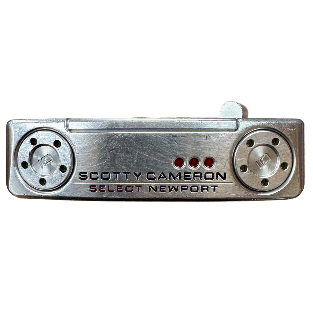 Titleist Scotty Cameron Select Newport Blade Putter RH Golf Club w/ Headcover Hand holding a Scotty Cameron Select Newport putter head on a wooden floor.