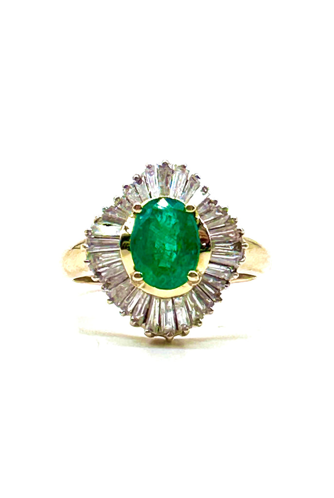 Ring with emerald and diamonds on a white background
