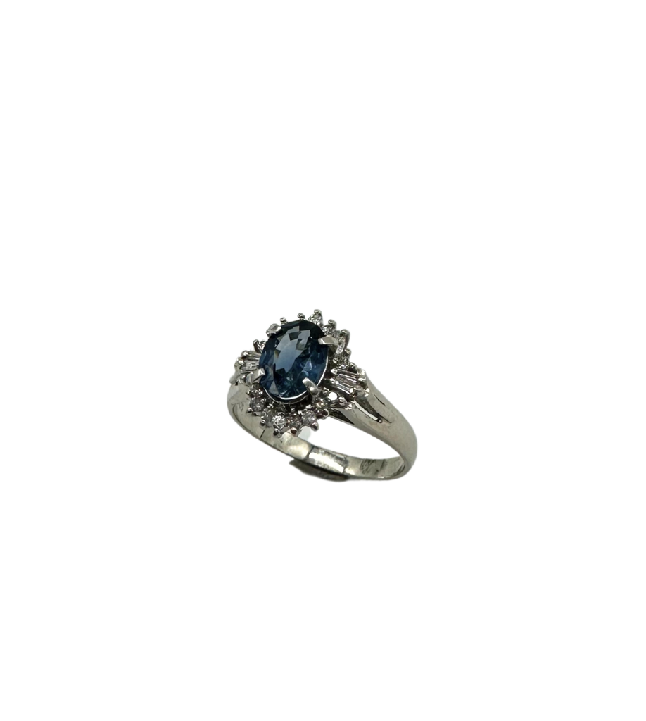 Silver ring with a blue gemstone on a white background