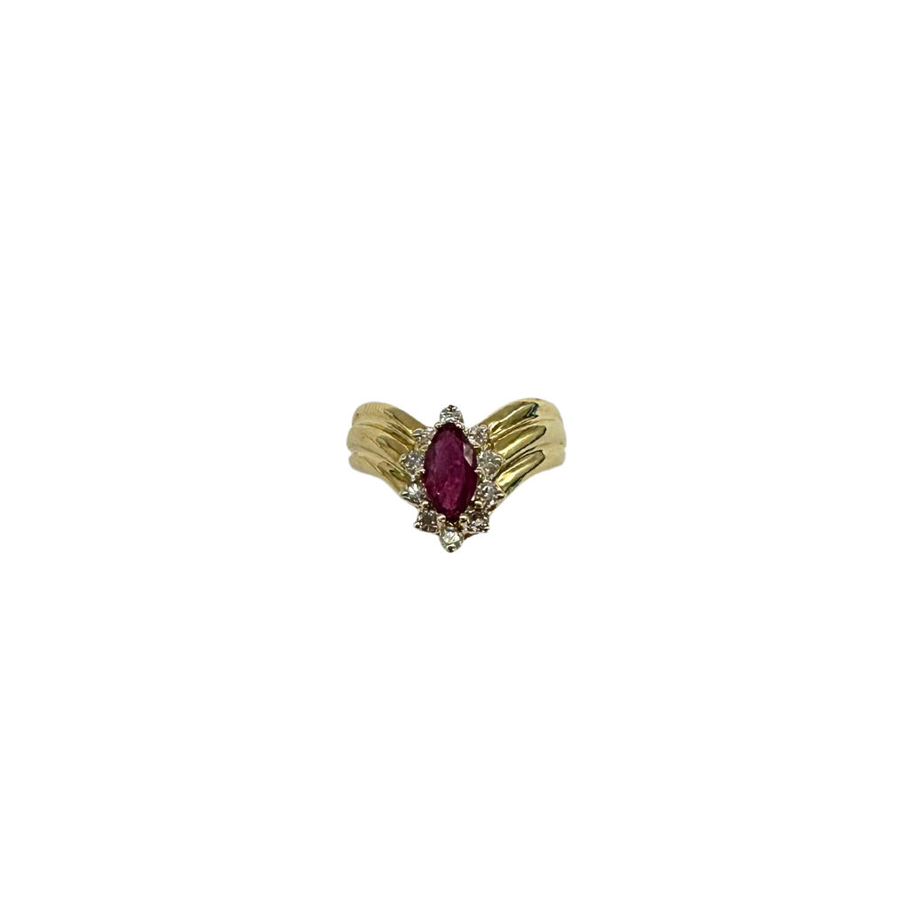 Gold ring with a red gemstone on a white background