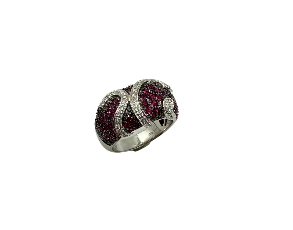 Silver ring with red gemstones on a white background