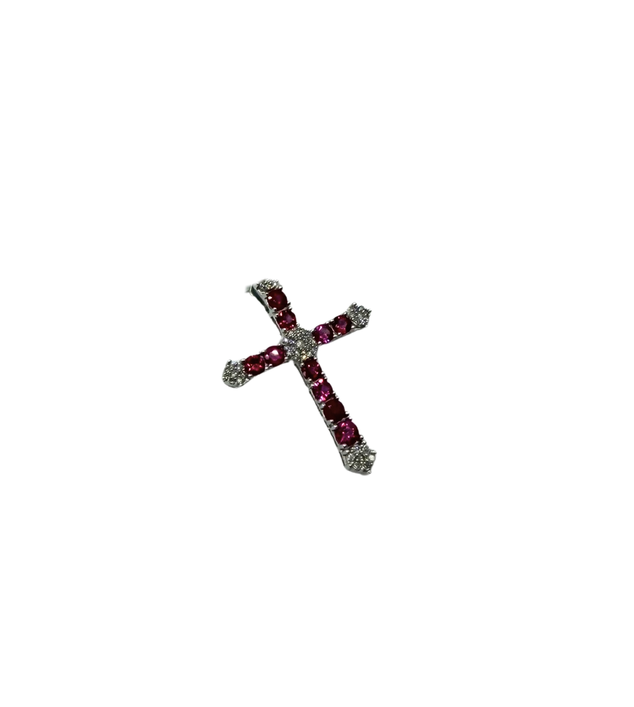 Silver cross pendant with red gemstones on a white background