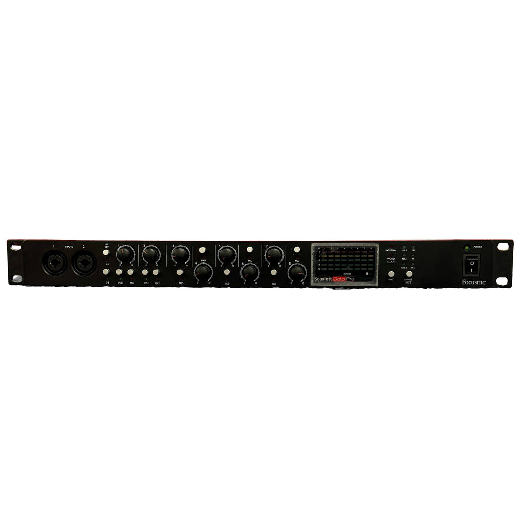 Focusrite Scarlett OctoPre 8-channel Microphone Preamp Red electronic equipment on a counter with deer heads mounted on the wall in the background.