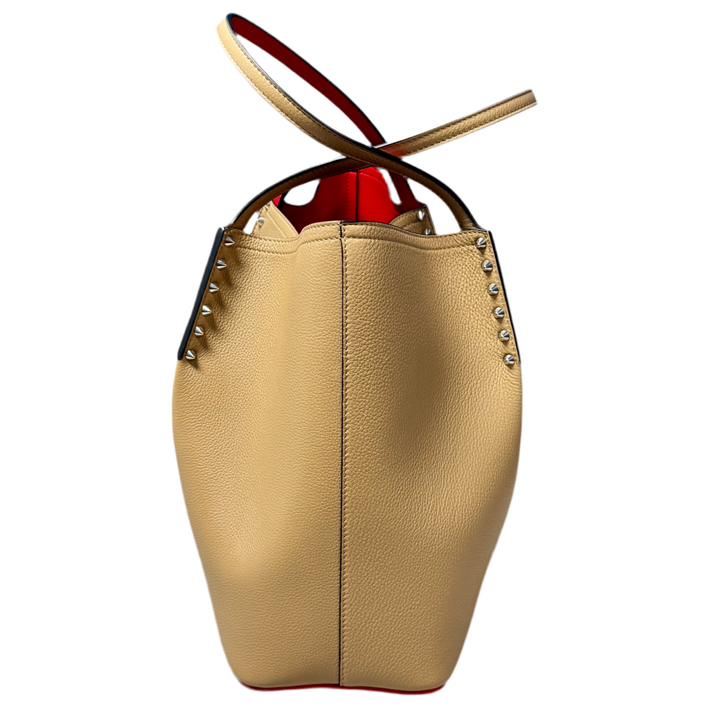Christian Louboutin Cabarock Large Calfskin Leather Tote Bag - Fennec Beige leather handbag with studded details on a white background