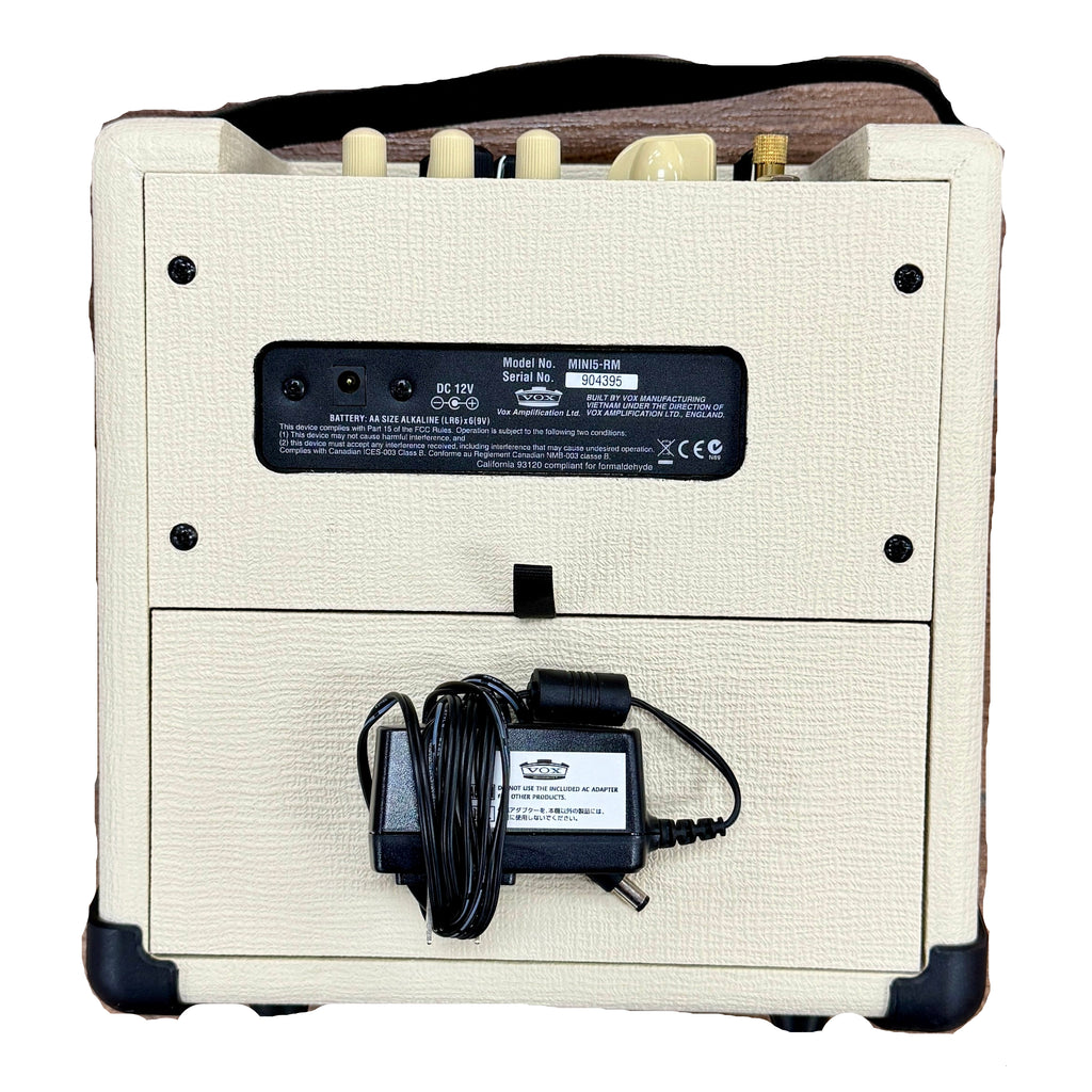 VOX MINI5 Rhythm Modeling Guitar Amplifier (MINI5-RM) Back view of a small amplifier with power cord on a wooden surface