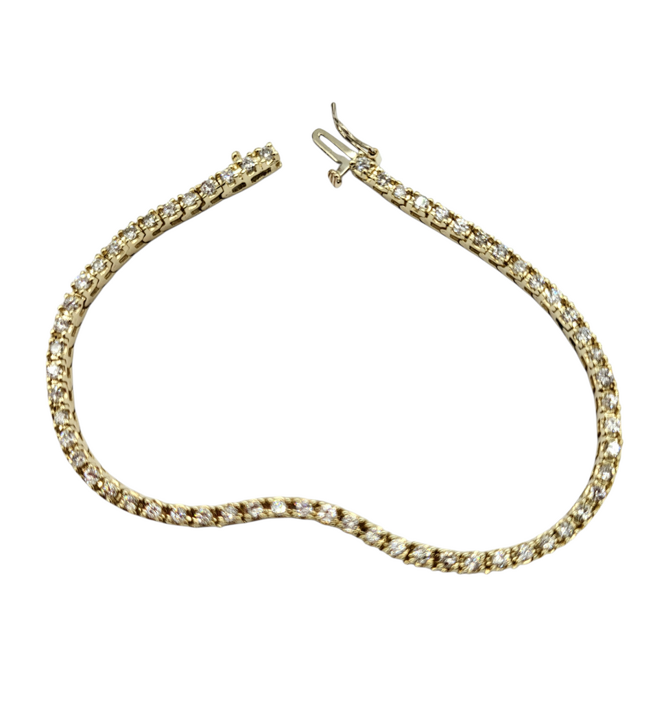 Gold bracelet with clear stones on a white background