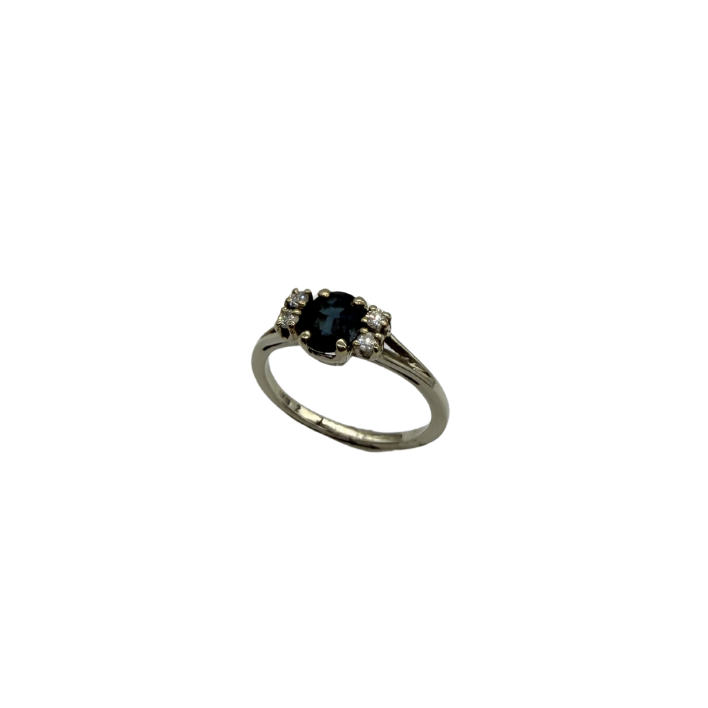 Silver ring with a black gemstone on a white background