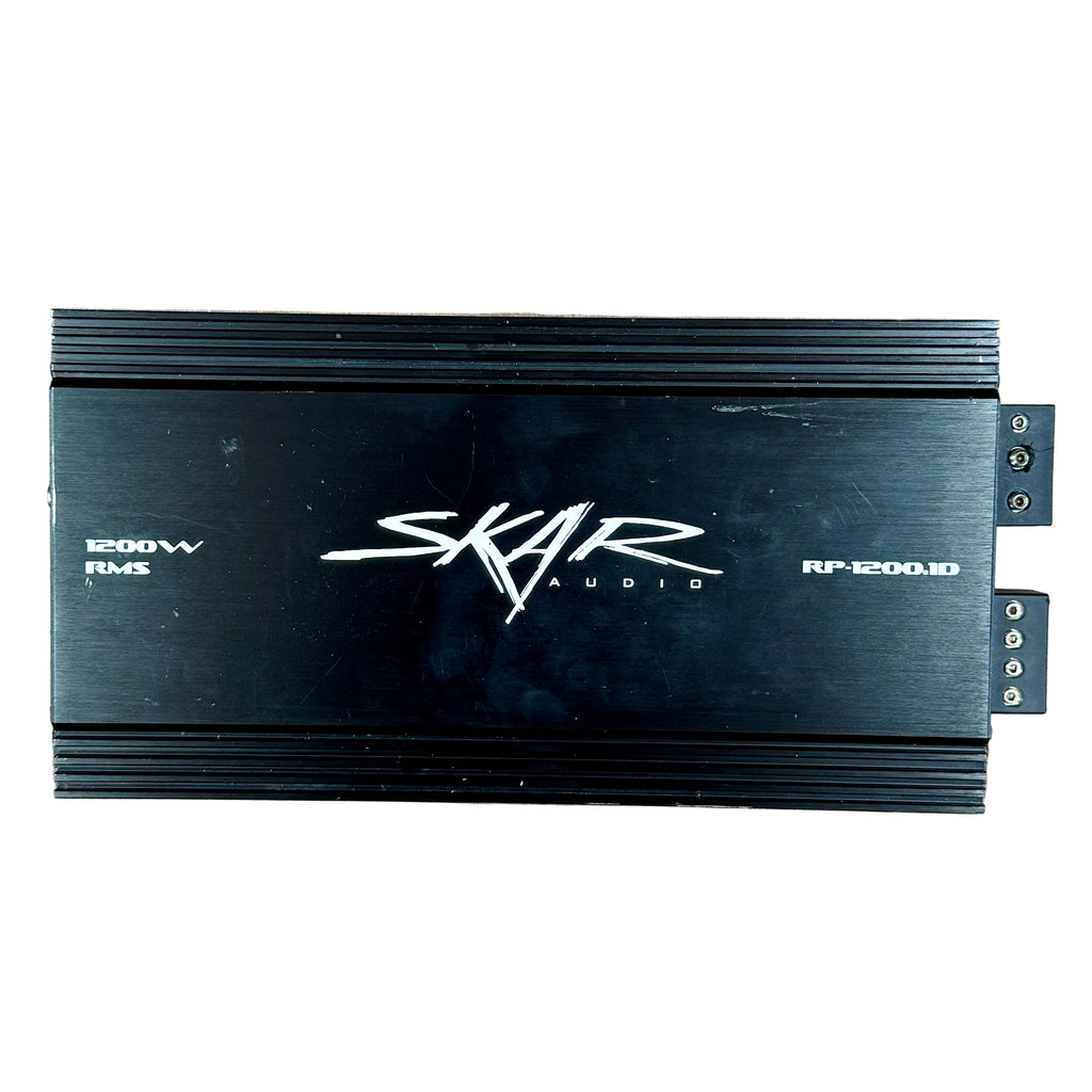 SKAR AUDIO RP-1200.1D 1200 Watt Class D Monoblock Car Amplifier Skar Audio amplifier on a wooden surface