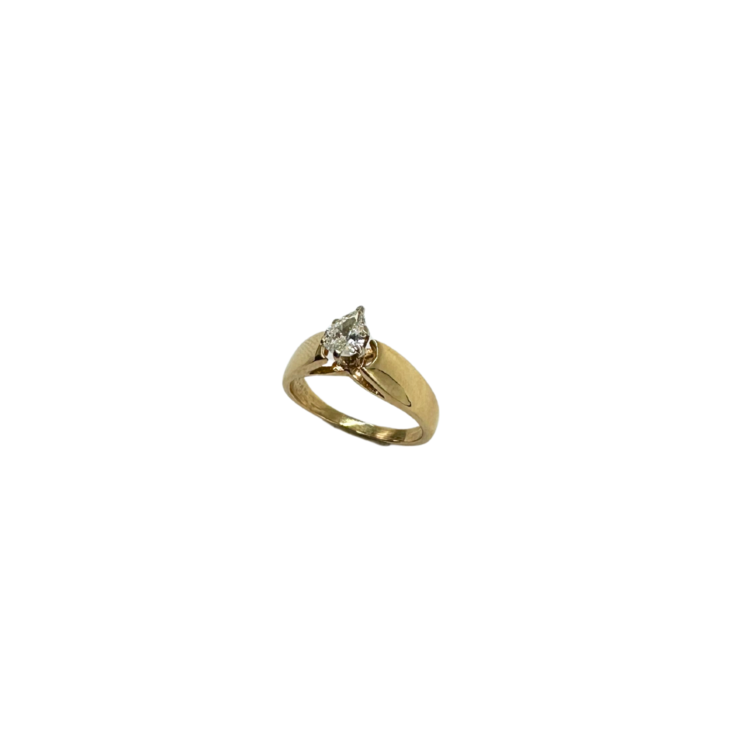 Gold ring with a diamond on a white background