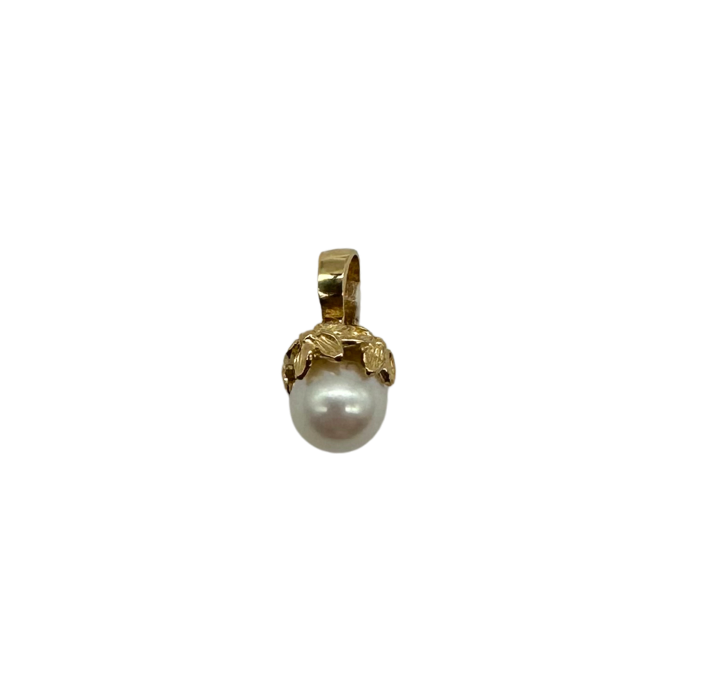 Gold pendant with a pearl on a white background
