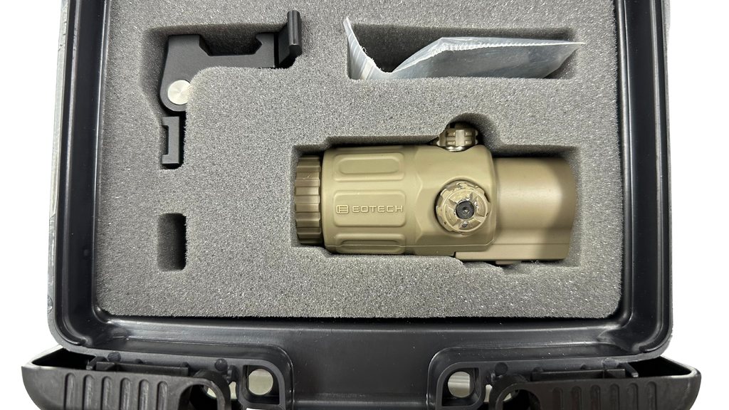 Tan tactical flashlight in a protective case on a white background