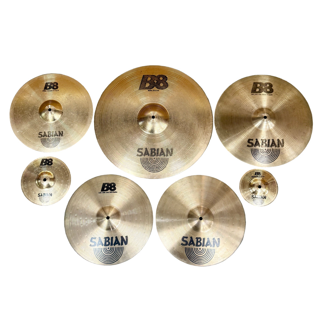 SABIAN B8 7-Piece Drum Cymbals Set (20" Ride, 16" Thin Crash, 14" Hi-Hats, 14" Thin Crash, 8" Splash, 6" Splash) Set of Sabian cymbals arranged on a wooden surface