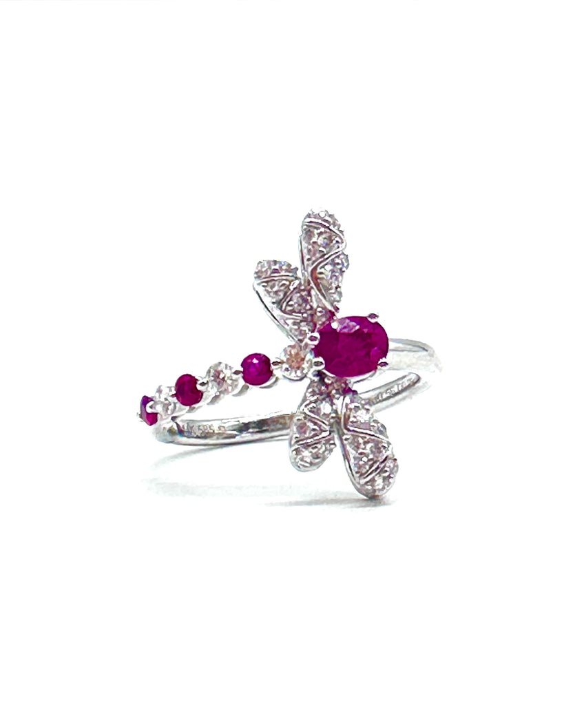 Silver ring with purple gemstones on a white background