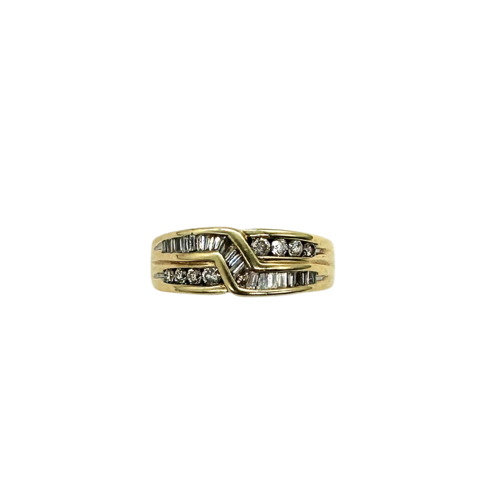 Gold ring with diamond accents on a white background