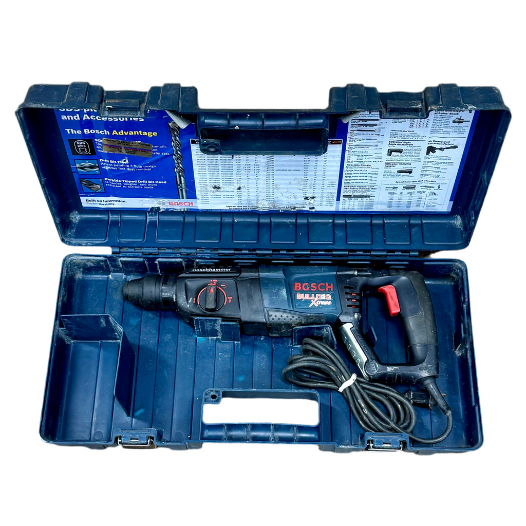 Bosch 11255vsr rotary hammer drill in an open blue case on a white background