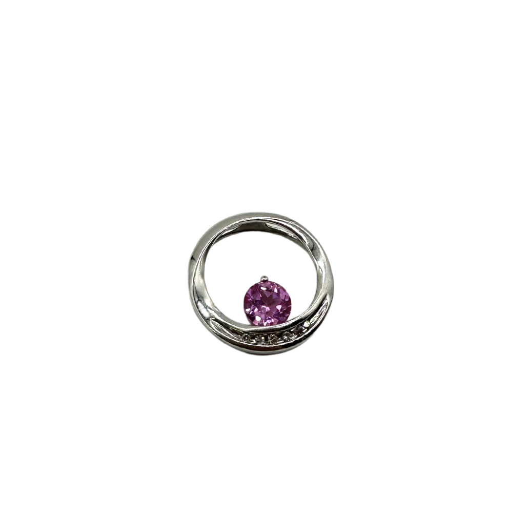 Silver ring with a purple gemstone on a white background