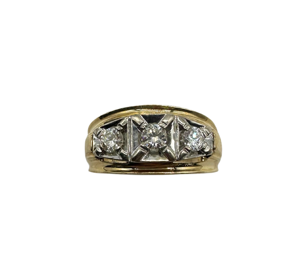 Gold ring with three diamond stones on a white background