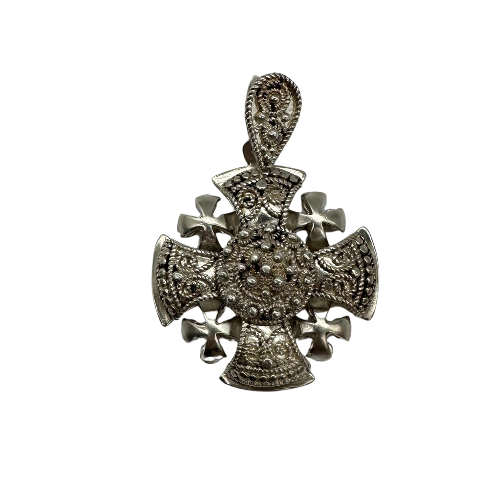 Silver cross pendant on a white background