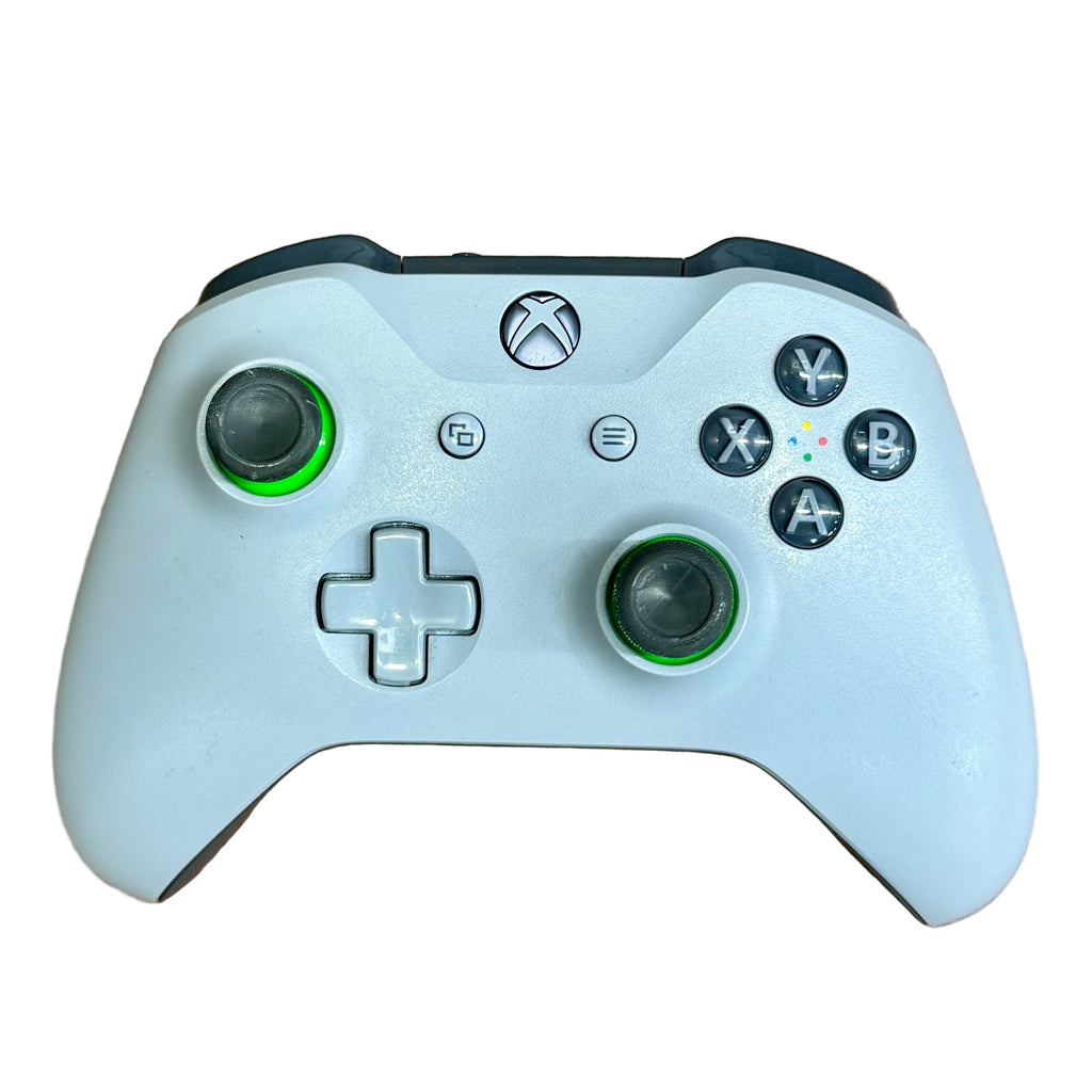 Microsoft Xbox One Wireless Controller - Grey/Green White gaming controller with green accents on a wooden surface