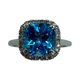 14K White Gold 1/4CTW Diamond Blue Topaz Halo Ring Ring with a blue gemstone and diamond-studded halo on a white background